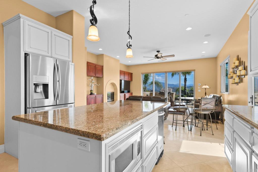 164 Dawn View Way El Cajon, CA 92021 - Photo 18 of 38 a kitchen with stainless steel appliances granite countertop a sink a stove and a refrigerator