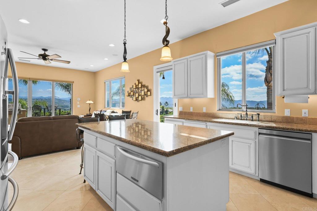 164 Dawn View Way El Cajon, CA 92021 - Photo 19 of 38 a kitchen with stainless steel appliances granite countertop a sink a stove and a wooden floor
