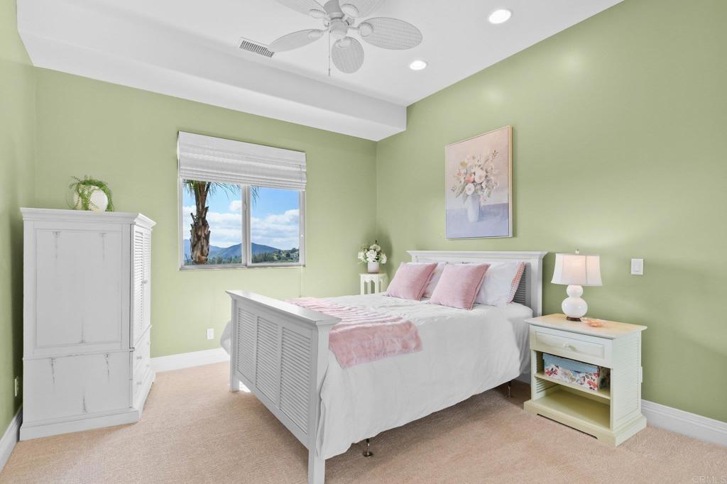 164 Dawn View Way El Cajon, CA 92021 - Photo 28 of 38 a bedroom with a bed and a chandelier