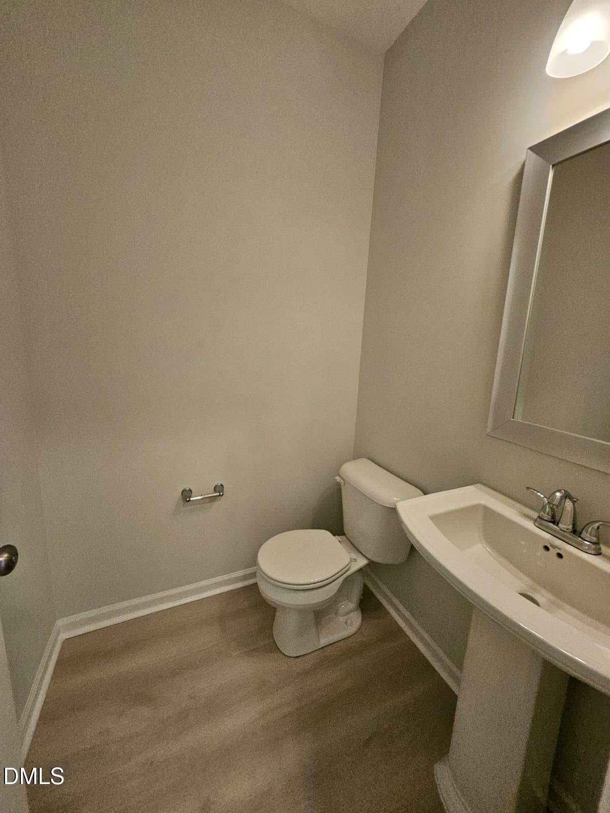 239 Tuscan Ridge Way Clayton, NC 27527 - Photo 14 of 36 a white toilet sitting next to a bathroom sink