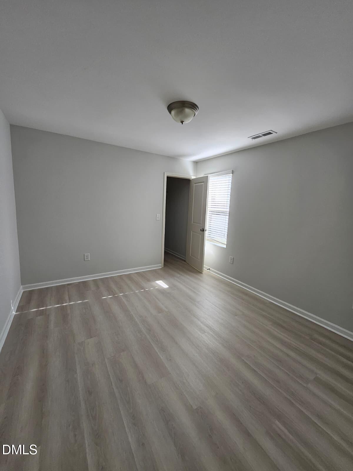 239 Tuscan Ridge Way Clayton, NC 27527 - Photo 30 of 36 a view of an empty room with wooden floor