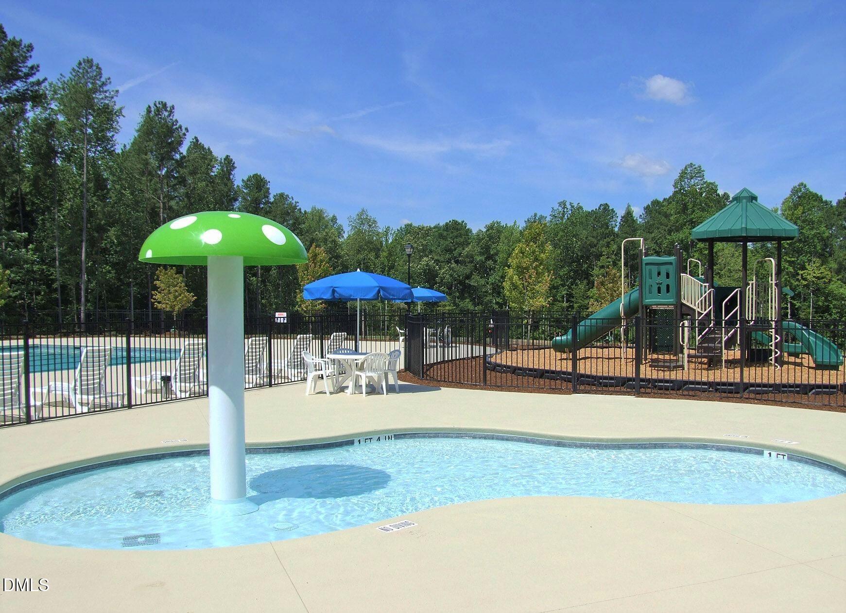 239 Tuscan Ridge Way Clayton, NC 27527 - Photo 36 of 36 a patio with a table and chairs under an umbrella