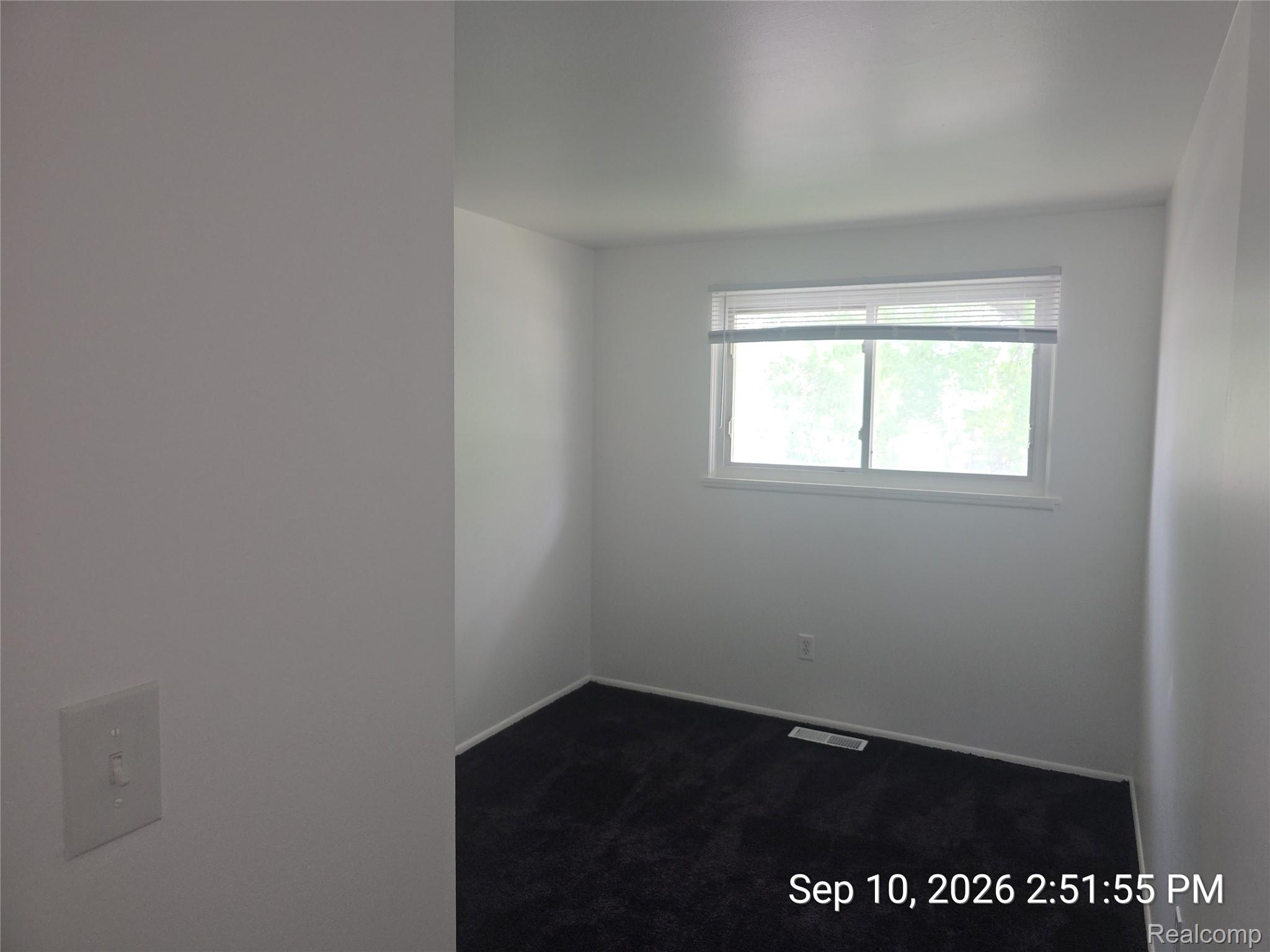 4882 Southfield Road Dearborn Heights, MI 48125 - Photo 12 of 15 White painted walls with dark carpet flooring