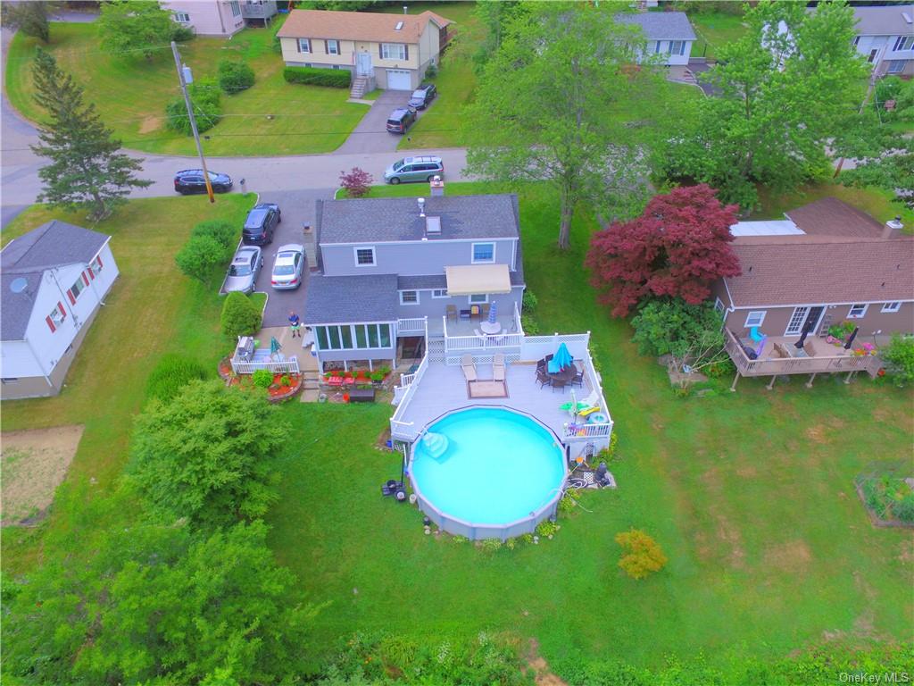 Aerial view of house with addition and pool
