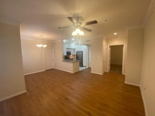 a view of a kitchen with a sink and a refrigerator