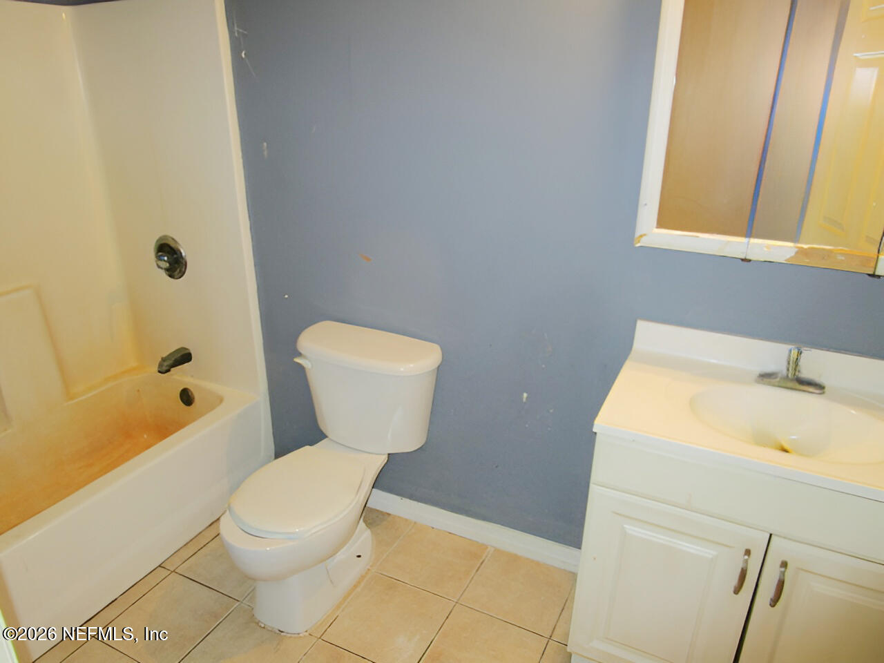 7070 3rd Street St. Augustine, FL 32092 - Photo 19 of 22 a white toilet sitting next to a bathroom sink