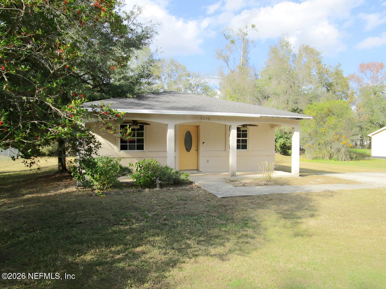 7070 3rd Street St. Augustine, FL 32092 - Photo 2 of 22 a view of a house with a yard and large trees