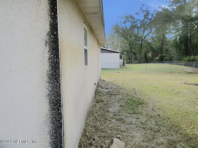 a view of a yard with trees