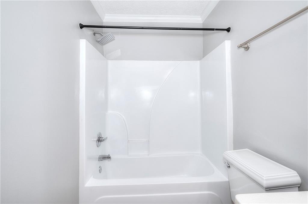 372 Ashton Way Winder, GA 30680 - Photo 12 of 29 a bathroom with a bathtub and a shower