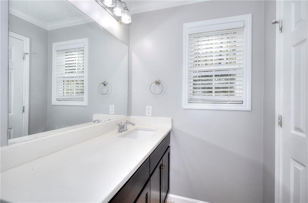 372 Ashton Way Winder, GA 30680 - Photo 13 of 29 a bathroom with a sink a vanity and a mirror