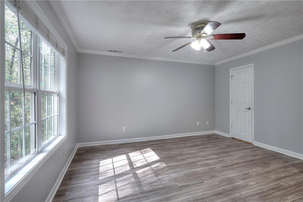 372 Ashton Way Winder, GA 30680 - Photo 14 of 29 a view of empty room with wooden floor and fan