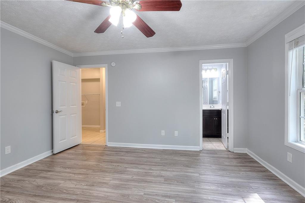 372 Ashton Way Winder, GA 30680 - Photo 15 of 29 a view of an empty room and window and wooden floor