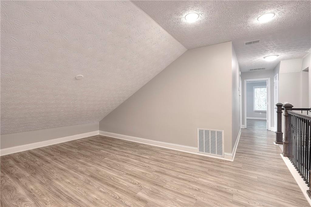 372 Ashton Way Winder, GA 30680 - Photo 18 of 29 a view of a hallway with wooden floor
