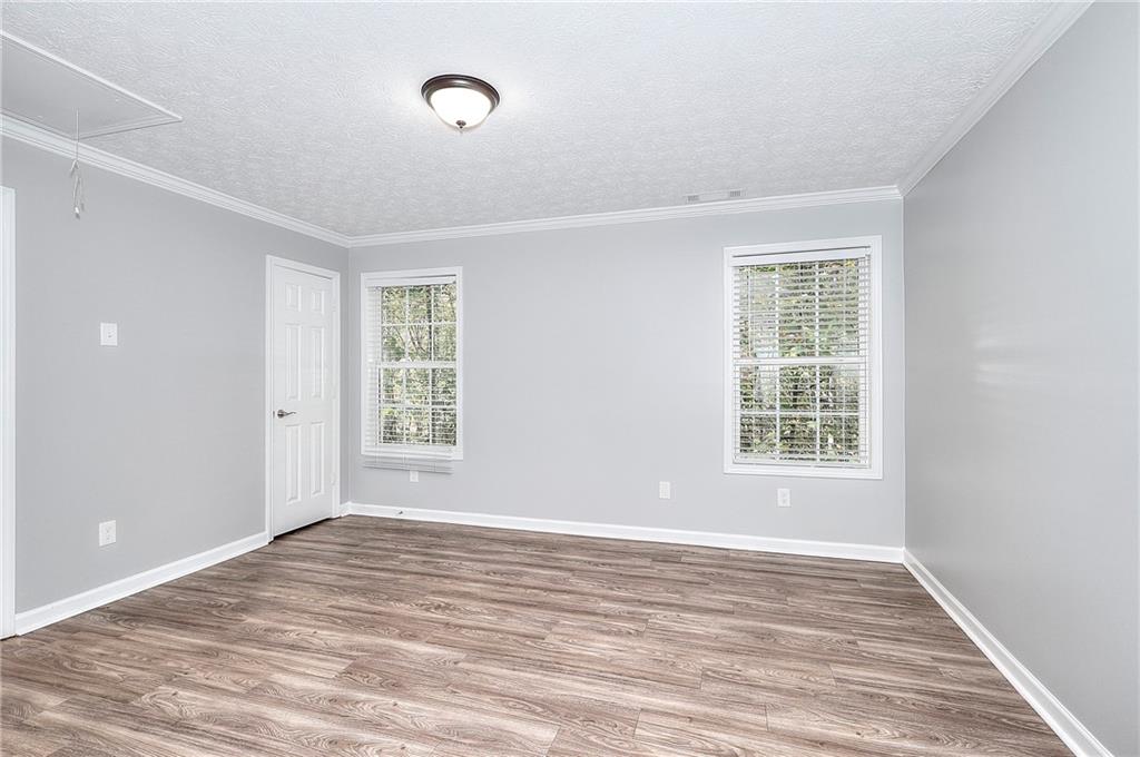 372 Ashton Way Winder, GA 30680 - Photo 19 of 29 an empty room with wooden floor and windows