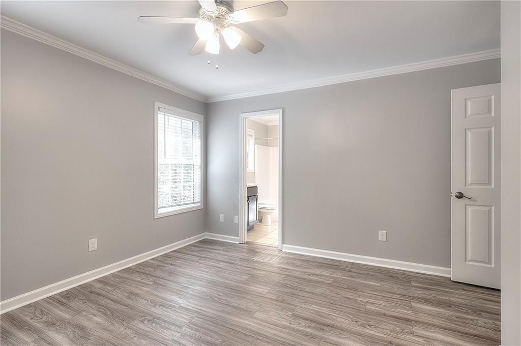 372 Ashton Way Winder, GA 30680 - Photo 24 of 29 a view of an empty room with wooden floor and a window
