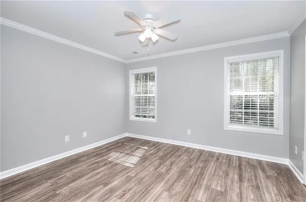 a view of a room with wooden floor and window