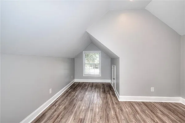 a bathroom with a granite countertop sink a mirror and a bathtub