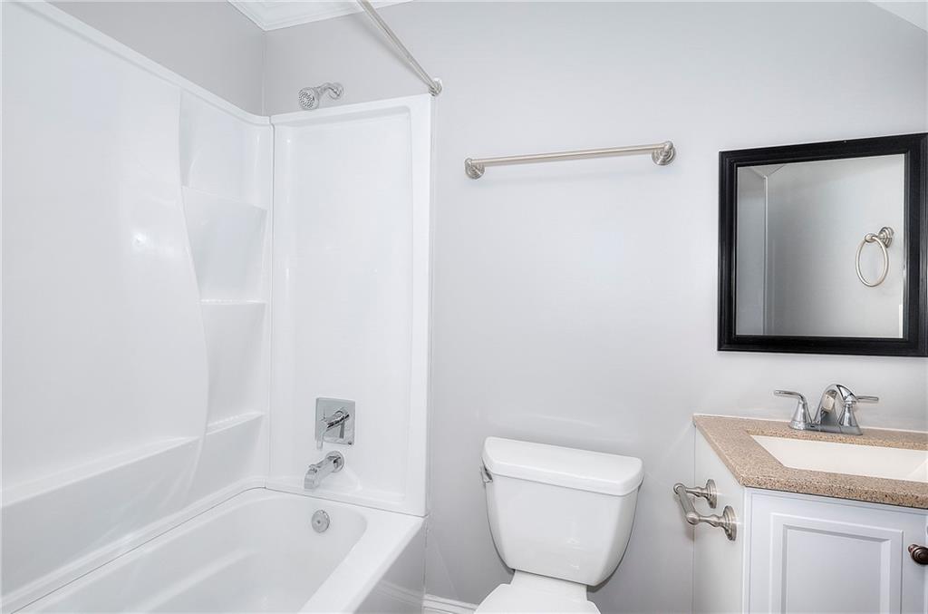 372 Ashton Way Winder, GA 30680 - Photo 27 of 29 a bathroom with a granite countertop sink a mirror and a bathtub