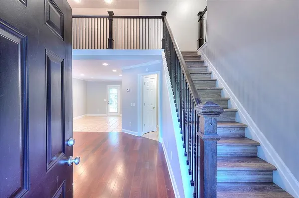 a view of entryway and hall with wooden floor