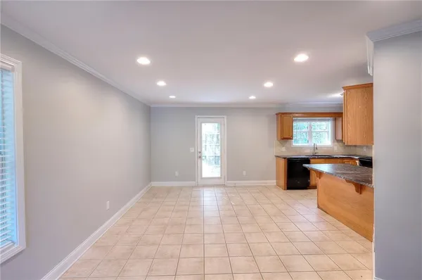 a view of a kitchen with a sink and a refrigerator