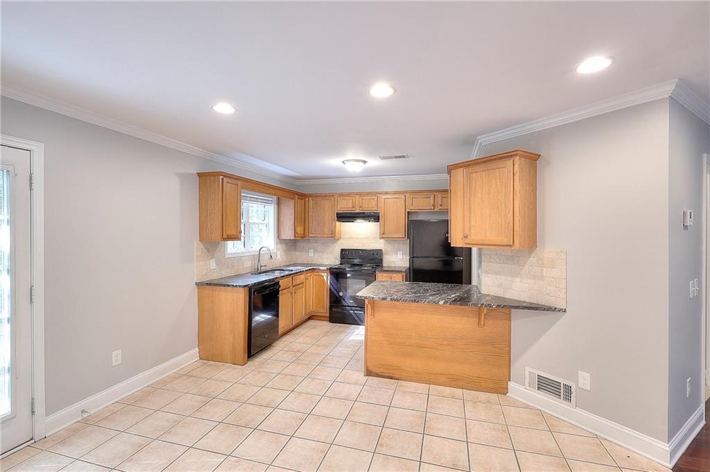 372 Ashton Way Winder, GA 30680 - Photo 8 of 29 a large white kitchen with cabinets
