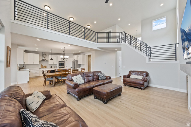 754 West 400 North, Unit 29 Mapleton, UT 84664 - Photo 4 of 25 Living area featuring light wood-style floors, a chandelier, and a high ceiling