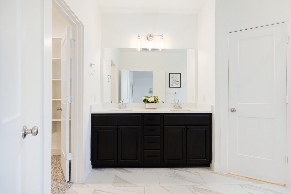 10122 Crescendo Way Manvel, TX 77578 - Photo 13 of 24 a bathroom with a sink vanity and mirror
