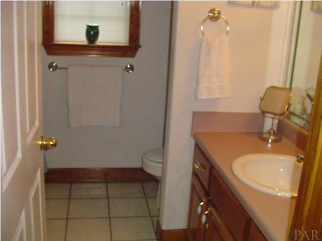 5330 Morgan Ridge Drive Milton, FL 32570 - Photo 16 of 25 Guest Bath with Wood Cabinets and Tub