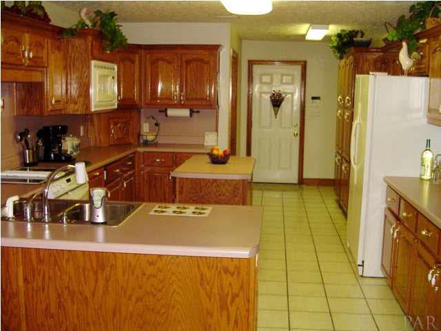 5330 Morgan Ridge Drive Milton, FL 32570 - Photo 6 of 25 Country Kitchen with Gorgeous Wooden Cabinets and Tile Flooring