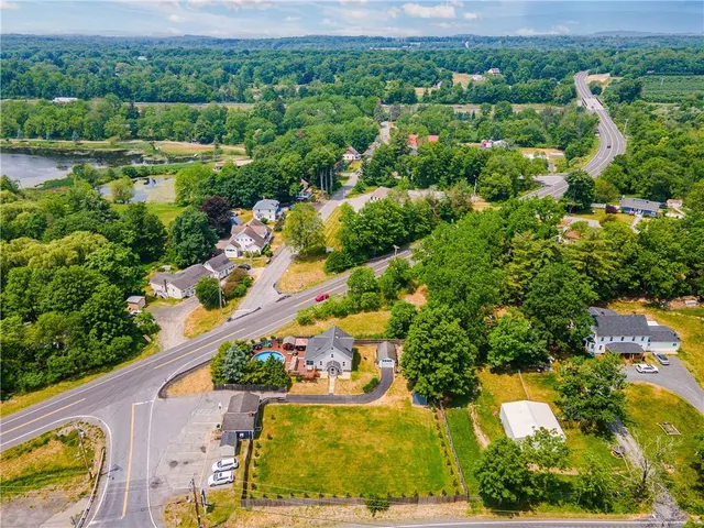 an aerial view of residential houses with outdoor space and street view