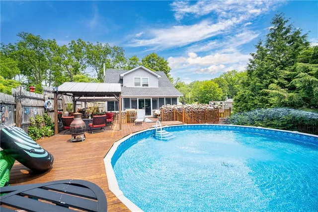 swimming pool view with a seating space