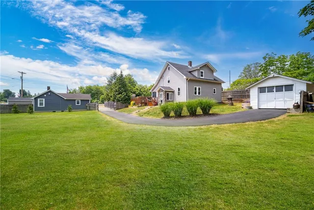 a front view of a house with a garden