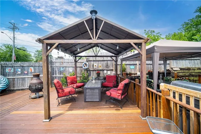 a view of a patio with table and chairs potted plants