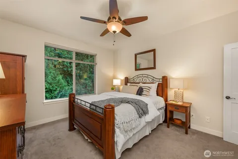 a bedroom with a bed and a ceiling fan