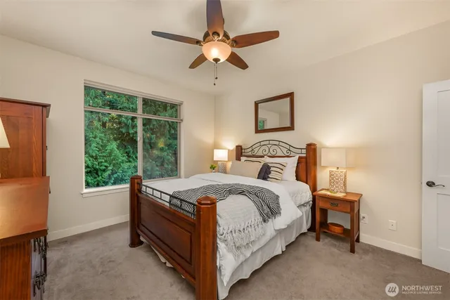 a bedroom with a bed and a ceiling fan