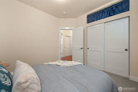 a bedroom with a bed and a hallway