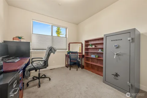 a view of a workspace with furniture and a window