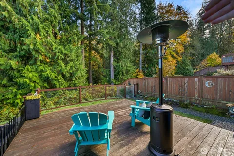 a view of a chair and table in backyard of the house