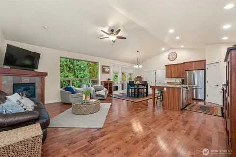 a living room with furniture a fireplace and a flat screen tv