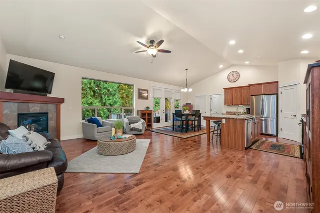 a living room with furniture a fireplace and a flat screen tv