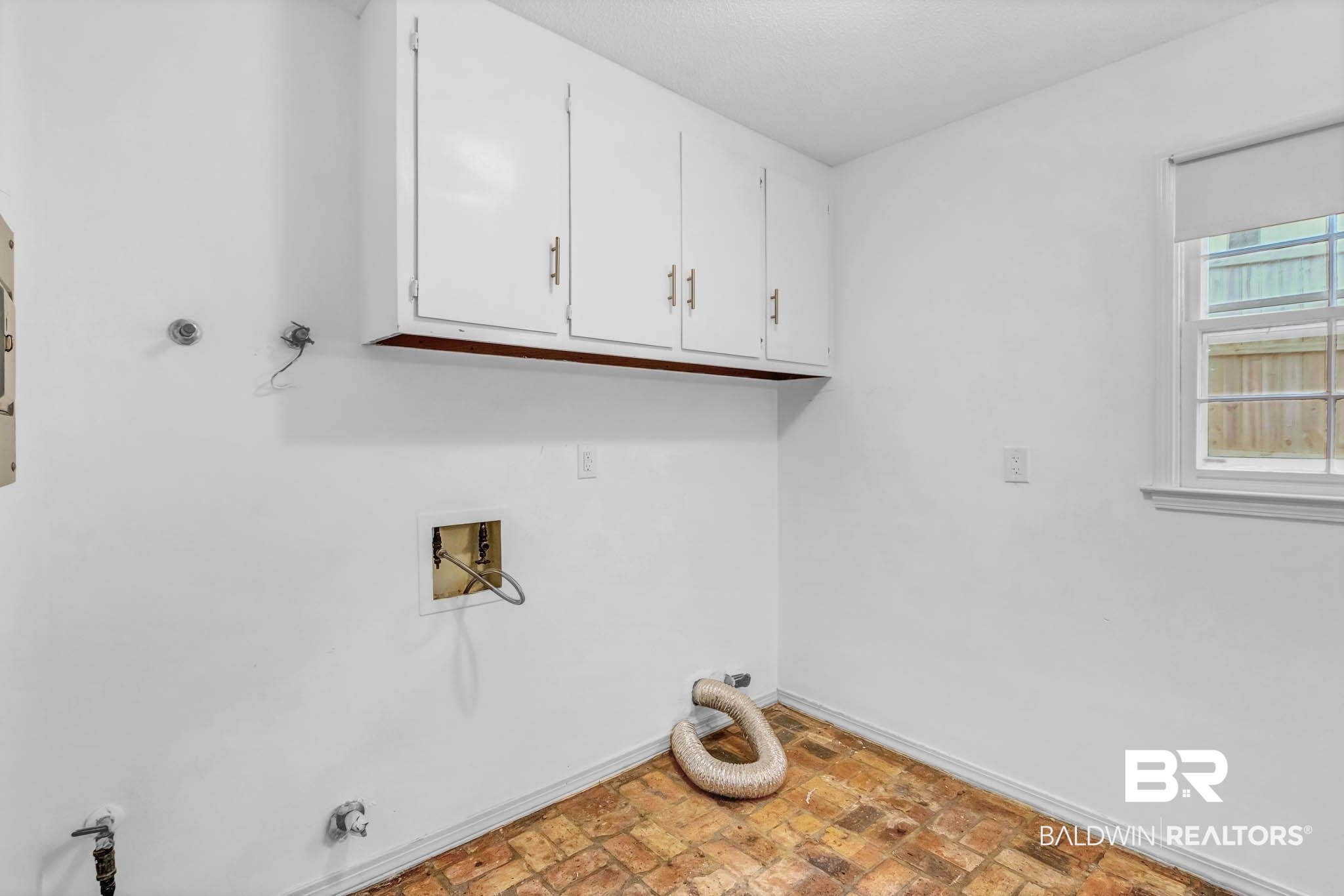 309 West Brandy Run Road Mobile, AL 36608 - Photo 59 of 100 Washroom featuring cabinet space, washer hookup, brick floors, electric dryer hookup, and gas dryer hookup