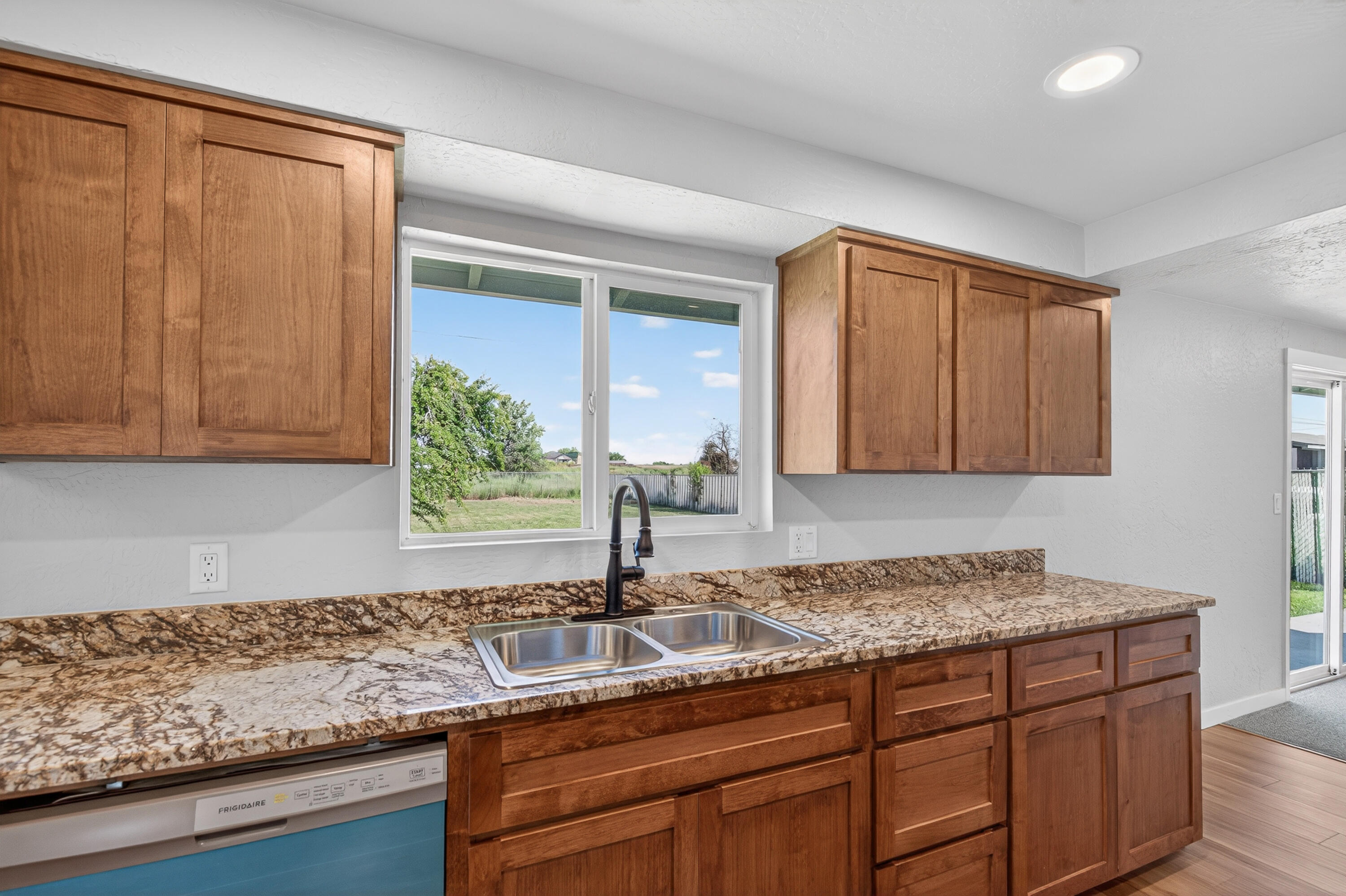 550 Experiment Station Road Medford, OR 97501 - Photo 7 of 27 a kitchen with granite countertop a sink a stove and cabinets