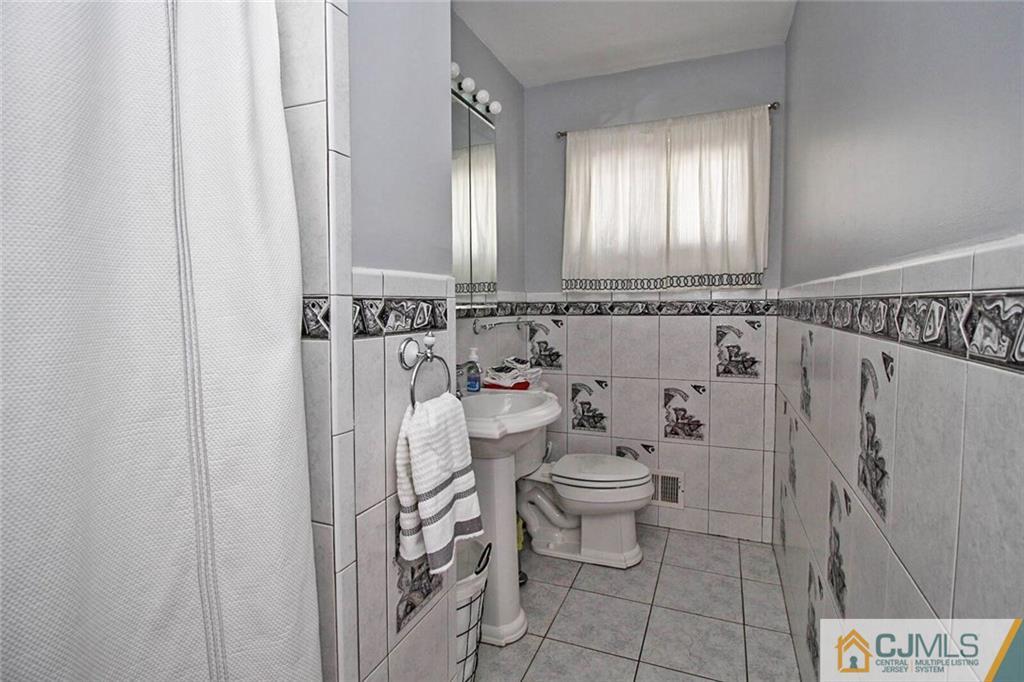 155 Princeton Road Old Bridge, NJ 08859 - Photo 11 of 18 a bathroom with a shower toilet and sink