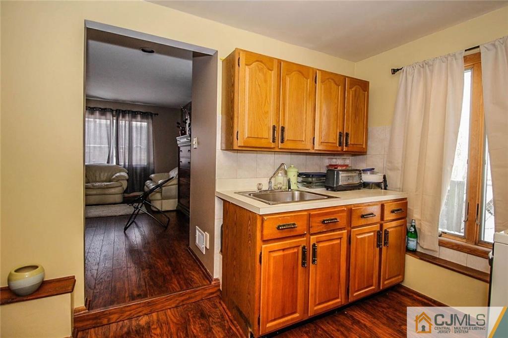 155 Princeton Road Old Bridge, NJ 08859 - Photo 14 of 18 a utility room with wooden floor a washer and dryer