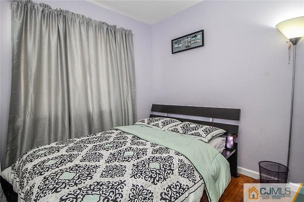 155 Princeton Road Old Bridge, NJ 08859 - Photo 7 of 18 a bed sitting in a bedroom next to a window
