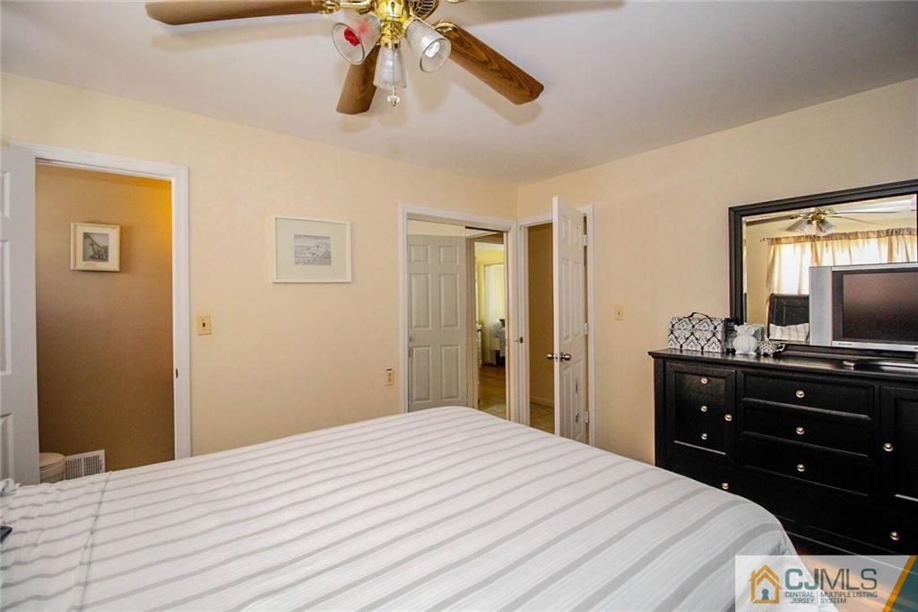 155 Princeton Road Old Bridge, NJ 08859 - Photo 9 of 18 a bedroom with a bed and a flat tv screen on dresser
