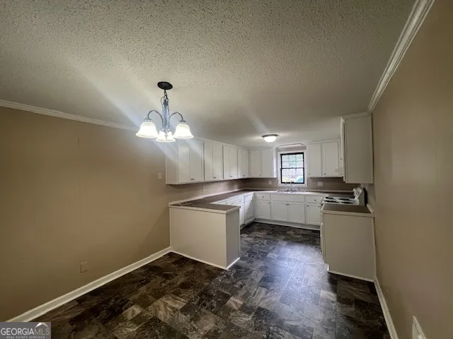 a kitchen with kitchen island a sink stainless steel appliances and cabinets