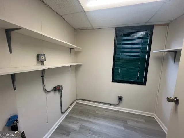 a room that has a wooden floor and a window