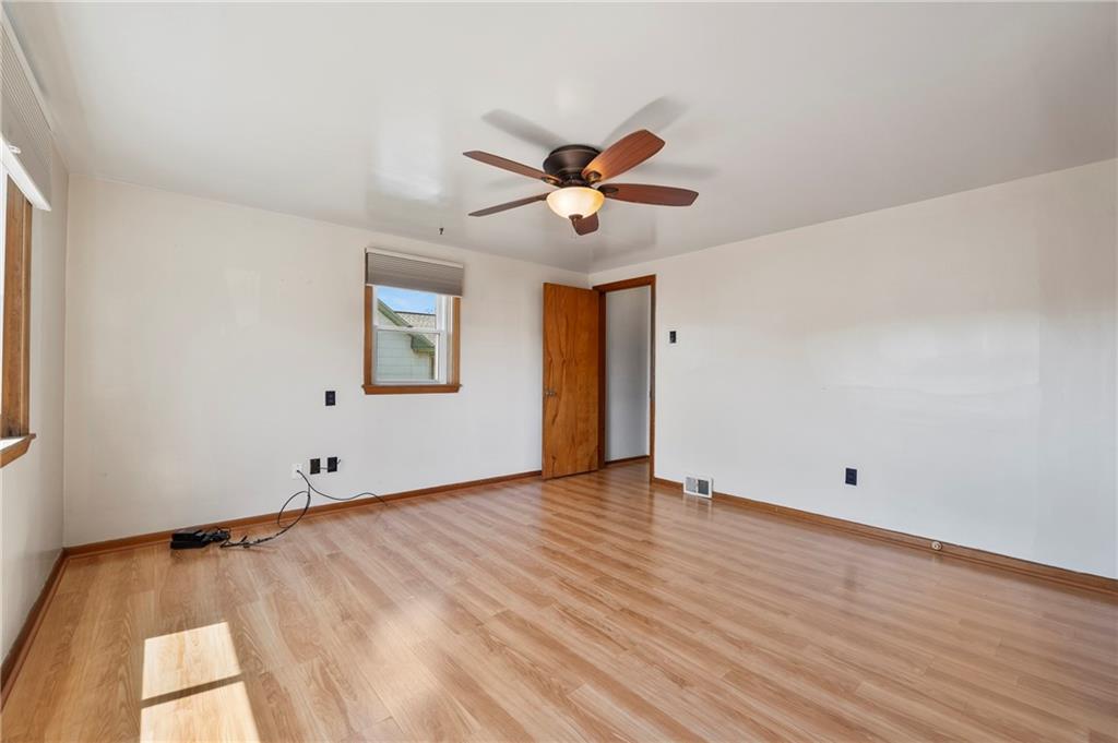 756 Mary Street McKees Rocks, PA 15136 - Photo 17 of 35 a view of an empty room with wooden floor and a ceiling fan