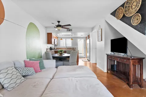 a living room with furniture and a wooden floor